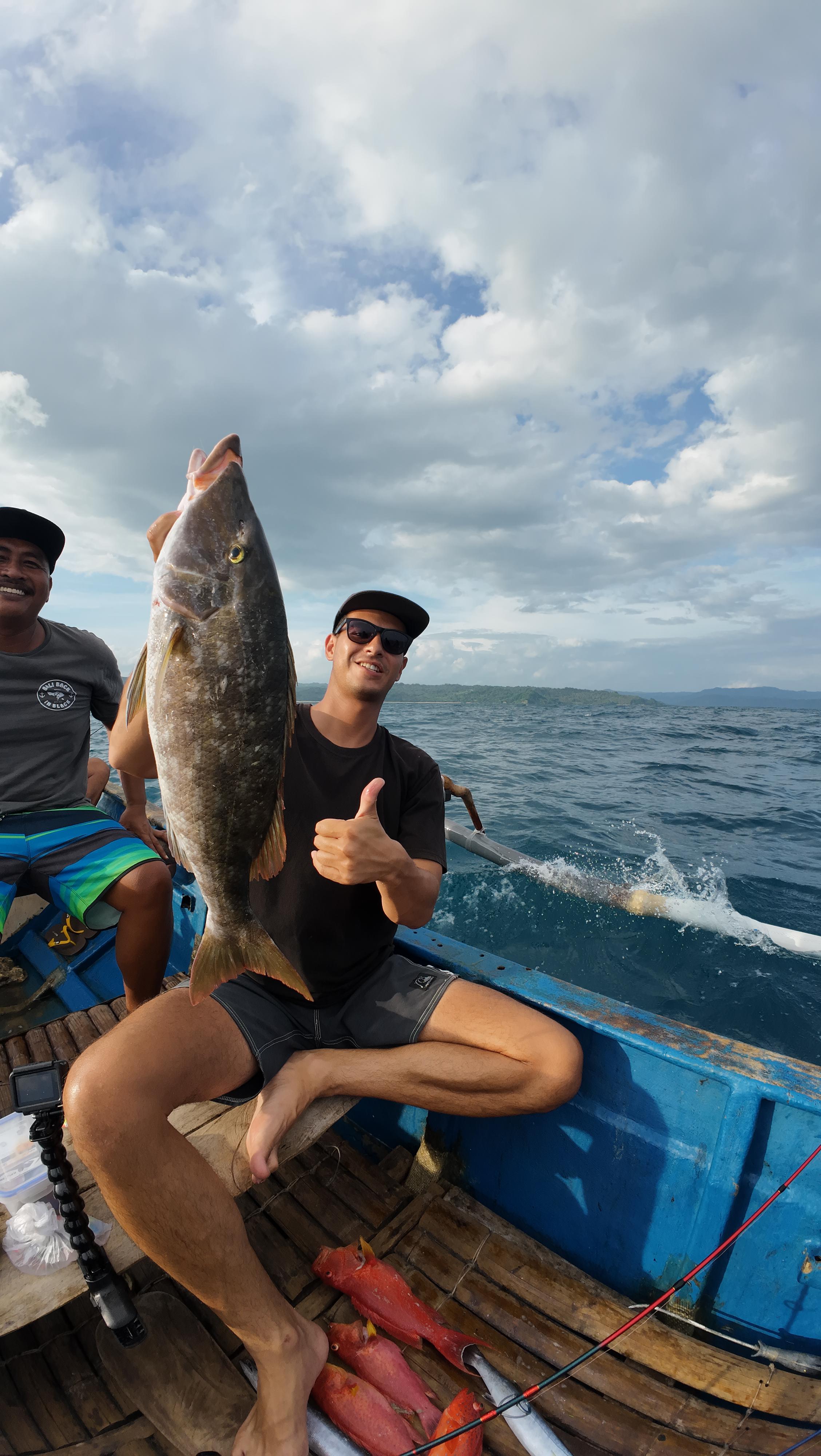 Guest holding two fish at once