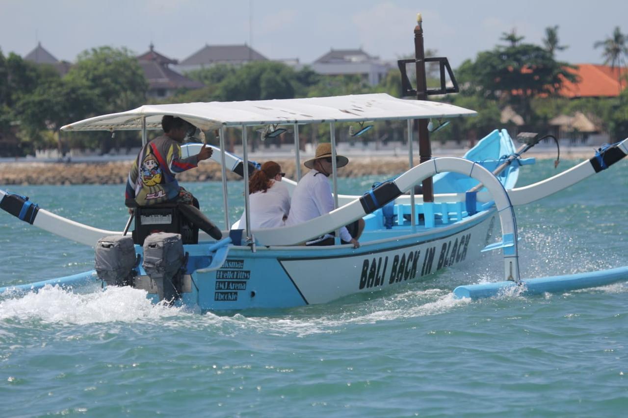Branded boat cruising off Kuta