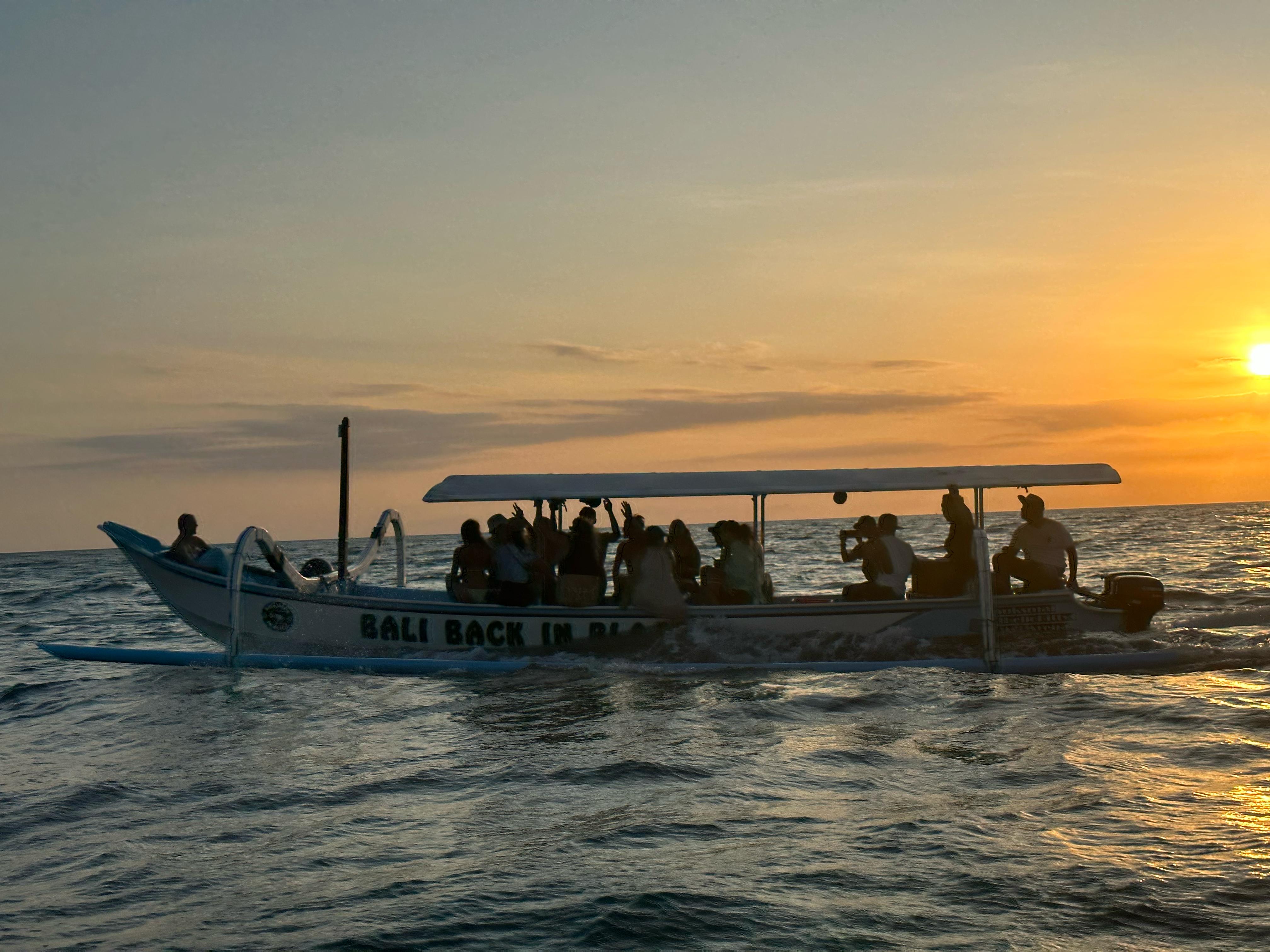 Group of friends on the party boat at sunset near Balangan